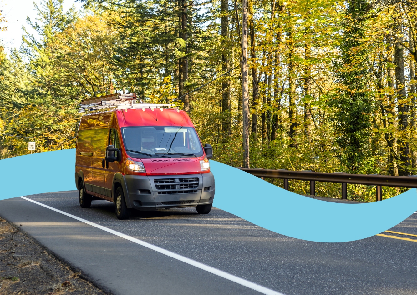 a fleet van drives in a wooded area