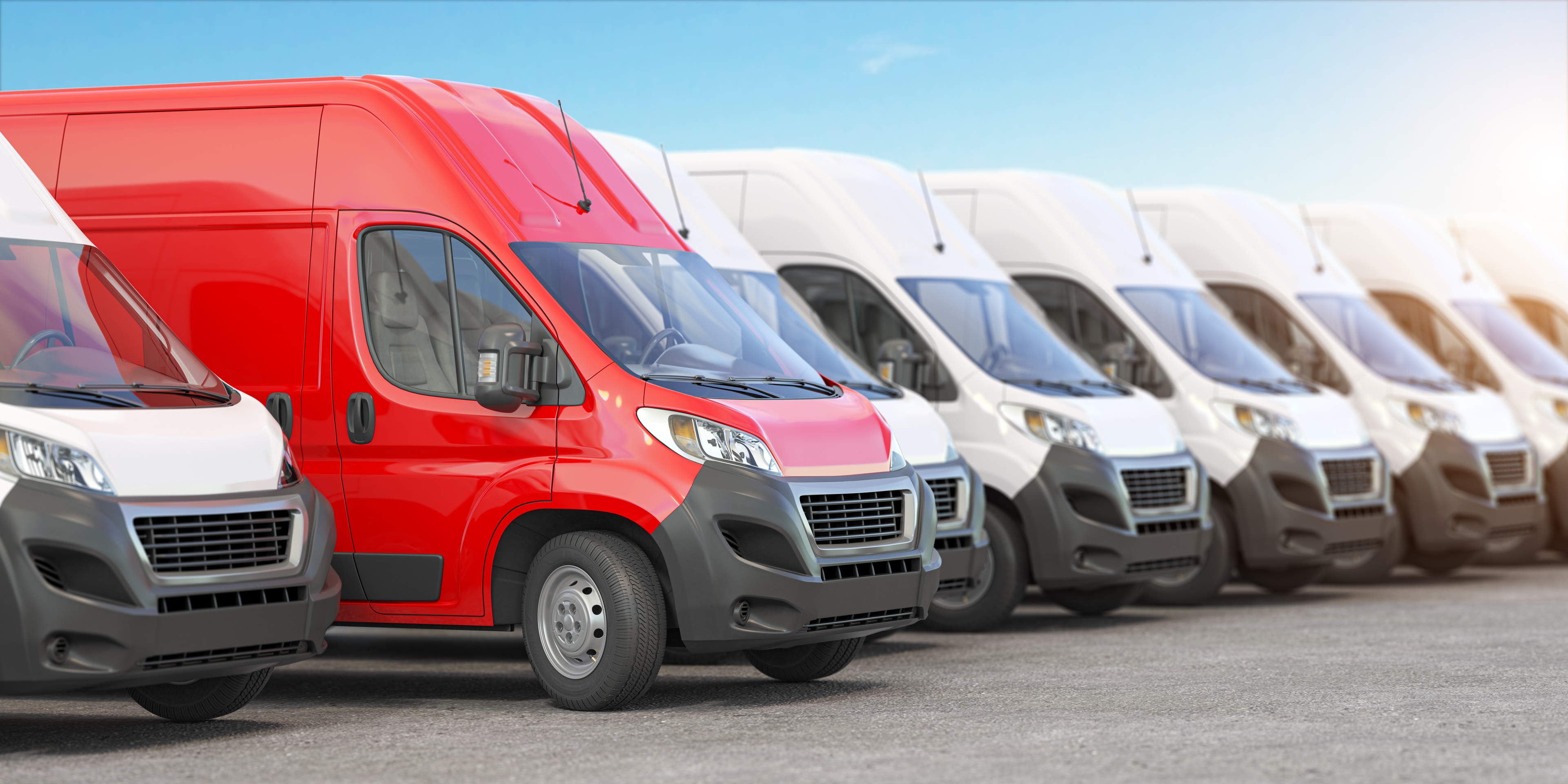 Red delivery van in a row of white vans. Best express delivery and shipemt service concept.