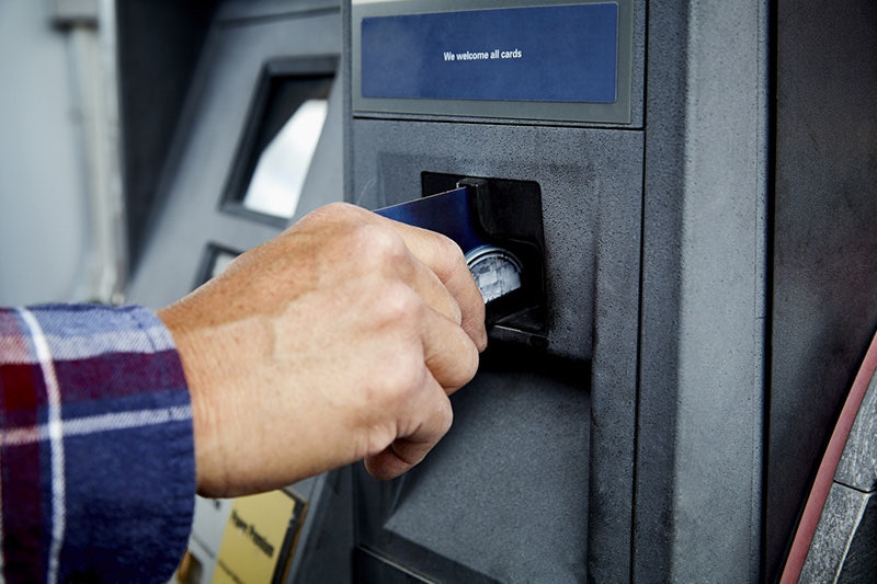 Man using a fleet credit card at the gas pump