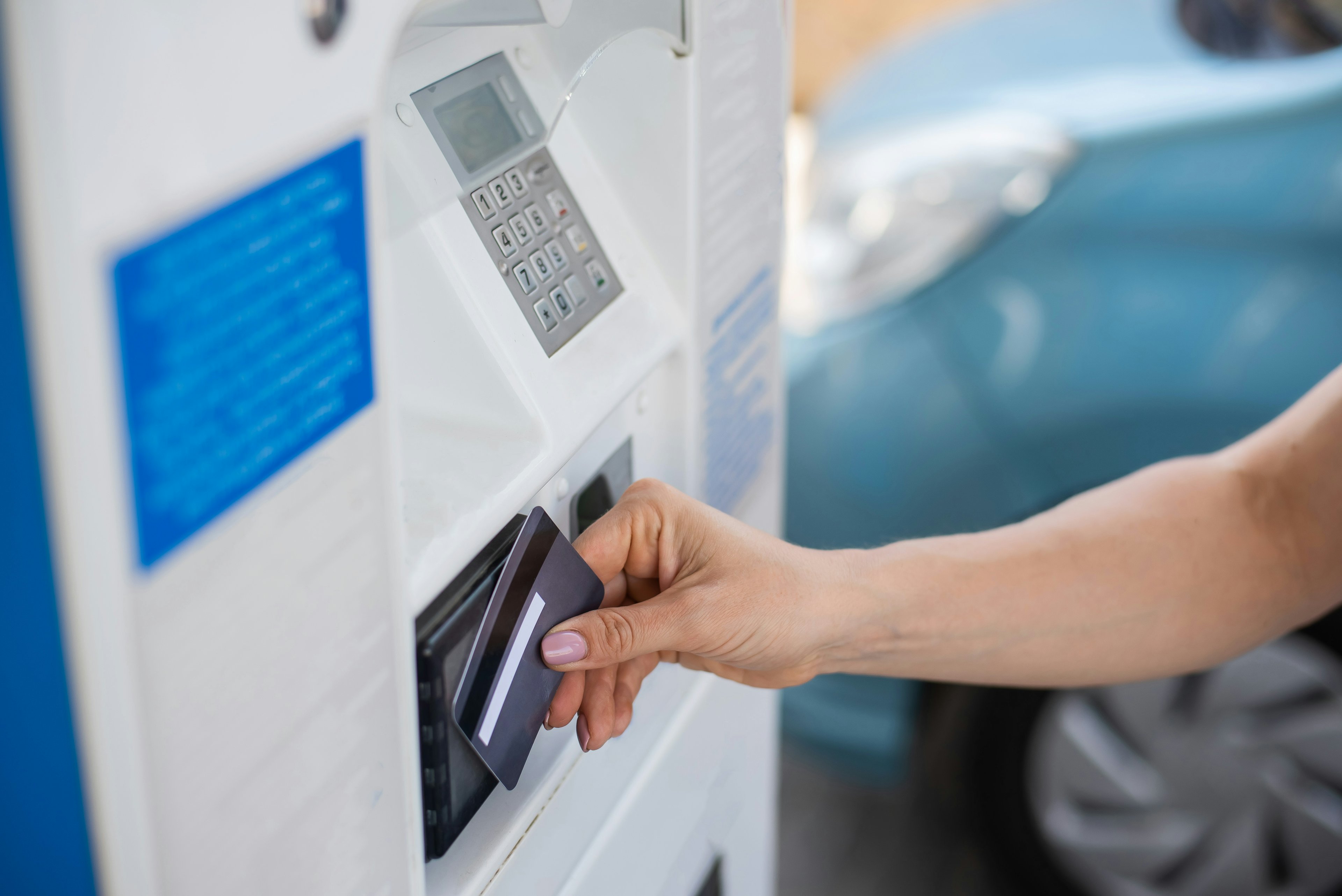 A Woman Fills Her Car With Gasoline At A Self Service Gas Station And Pays With A Credit Card At A Machine