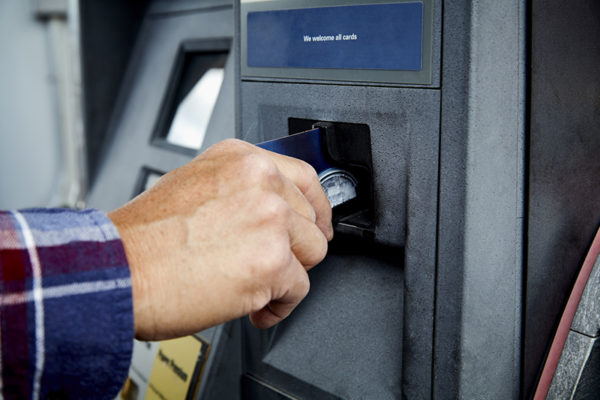 Man using universal fleet card for gas