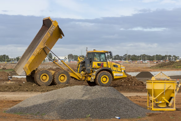 construction vehicles dumping dirt