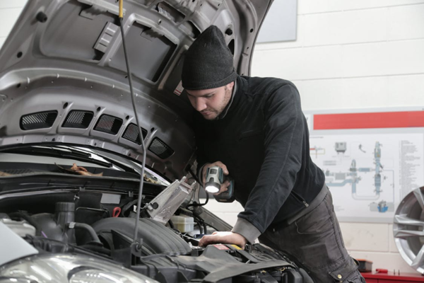 fleet mechanic working on a fleet car