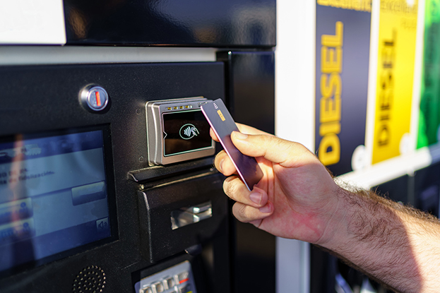 Man tapping card at gas station