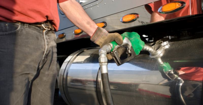 Man filling up his trucking fleet with gas